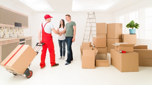 Professional movers handling household furniture in a local home